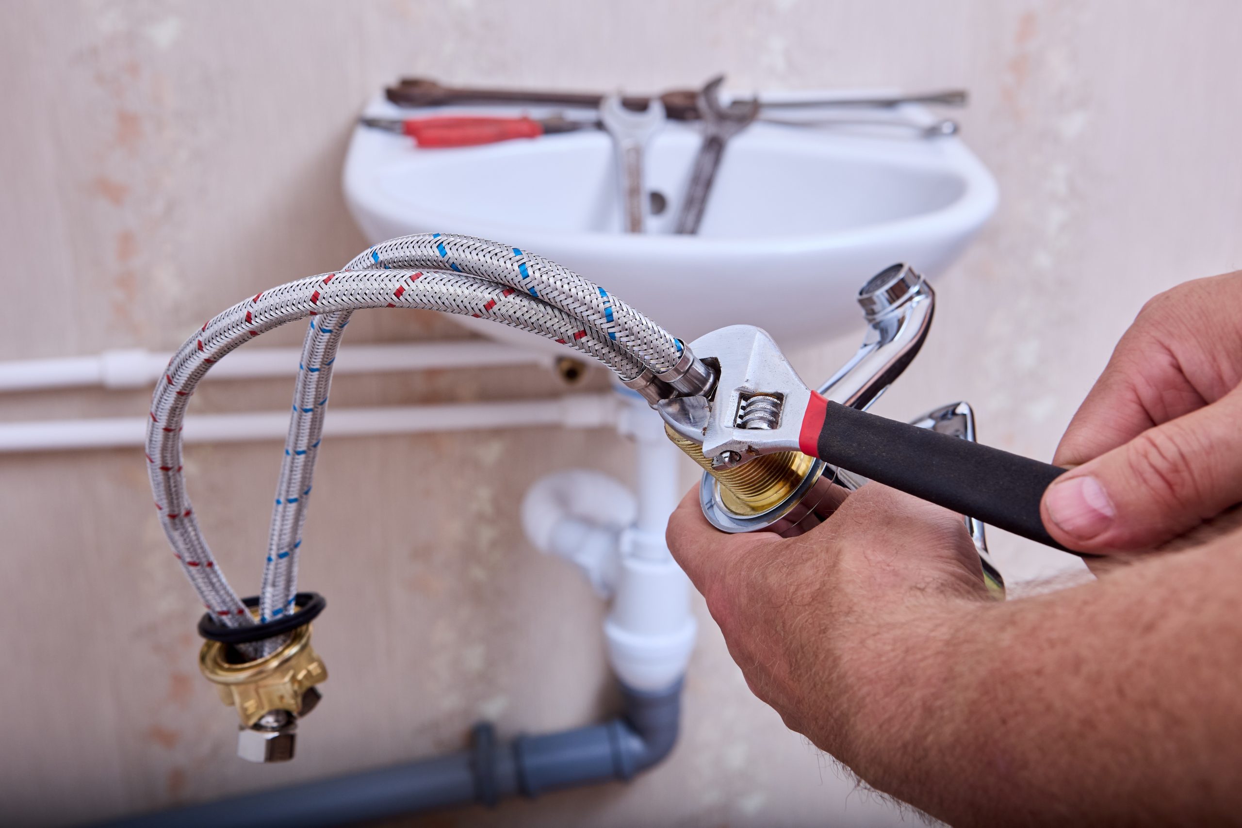 Plumber working on water lines for sink