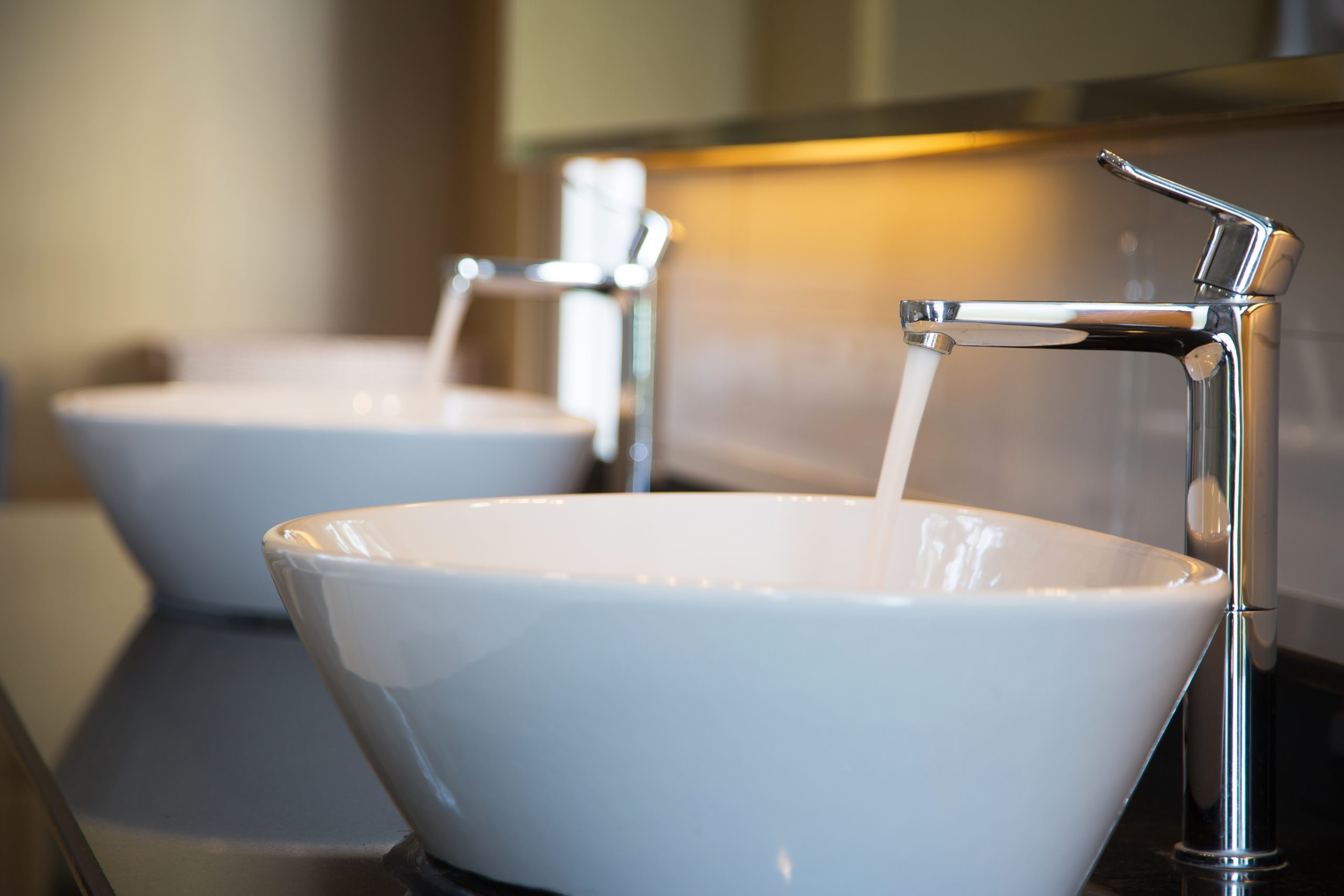 Two bathroom sinks with running water